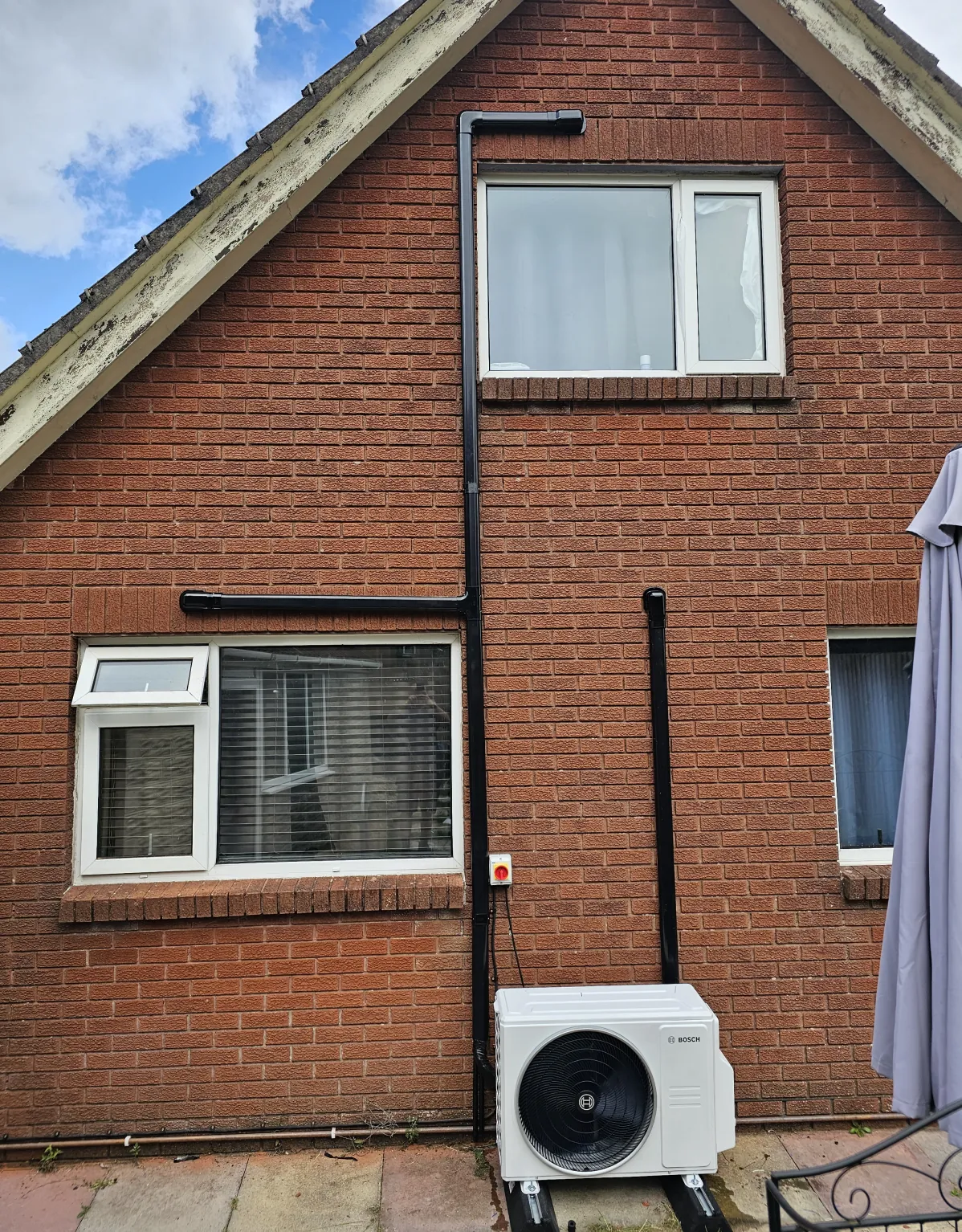 Outdoor unit at a brick home